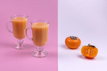 healthy persimmon juice and persimmon fruit on a colored background