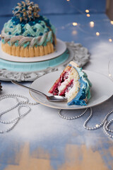 
Delicious and beautiful Christmas cake in the form of a knitted hat, sprinkled with powdered sugar. Vanilla biscuit with cranberry filling. New year cake