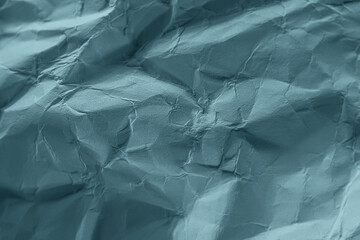 Crumpled paper in blue-green pastel color. Tidewater Green. Abstract trending background image.
