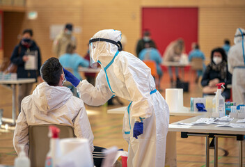 Massive rapid COVID-19 testing for the  popolation. Health workers in protective suits are engaged...