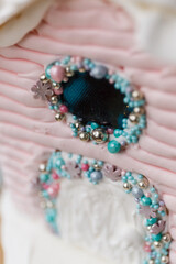 A beautiful colored gingerbread house decorated with glaze with caramel windows on a blue background. New Year's gift for children and the whole family