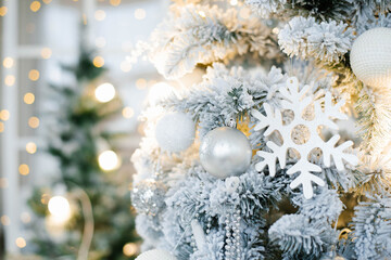 Elegant beautiful silver Christmas tree with white and gold balloons close up. Background for copy space