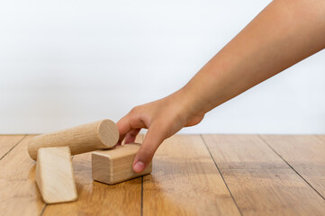 Kid playing with wooden blocks.