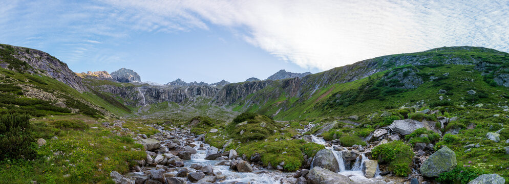 Summer view of alpine mountain valley with winding stream near Zillergrundl. Austria Zillertaler Alpen tirol.