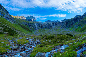 Naklejka na ściany i meble Summer view of alpine mountain valley with winding stream near Zillergrundl. Austria Zillertaler Alpen tirol.
