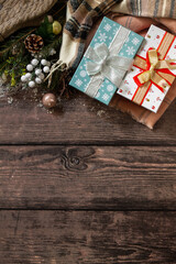 Fototapeta na wymiar Christmas concept. Christmas presents gift red box and blue box tree branch decor on a wooden table. Top view flat lay background.
