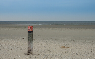 Wooden beach pole along the Dutch coast of Ameland