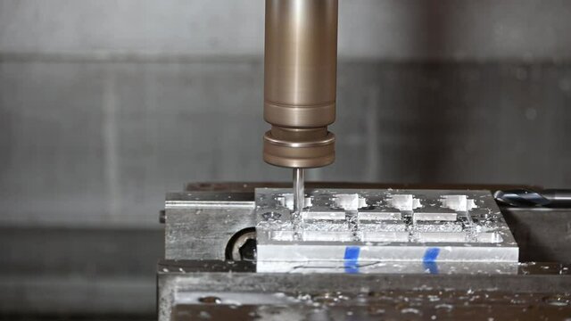 4K footage of CNC  milling machine finish cutting aluminum part by Flat solid end-mill tool. The hi-precision jig manufacturing concept by machining center. 