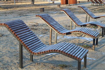 frosted deck chairs on a winter beach