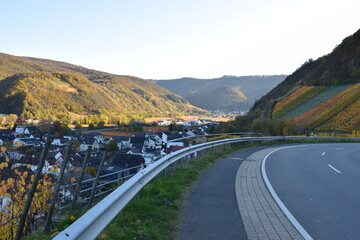 kurvige Straße durch die Weinberge ins herbstlich bunte Ahrtal bei Dernau