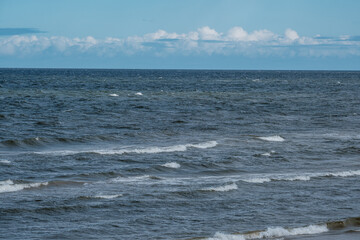 sea beach with white sand and blue water before storm