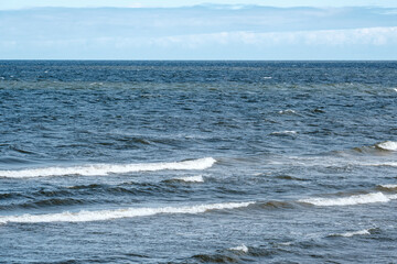 sea beach with white sand and blue water before storm