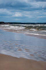 Fototapeta na wymiar sea beach with white sand and blue water before storm
