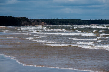 sea beach with white sand and blue water before storm