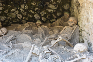Skeletons in Herculaneum, near Naples, Italy. These people were killed by a pyroclasic flow during the eruption of Mount Vesuvius in 79 AD.