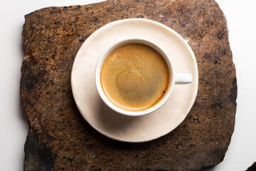 A cup of hot black morning coffee with a vintage marble table. A close up of americano or double espresso. Coffee break.
