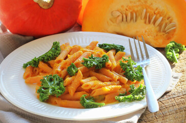 Creamy roasted pumpkin penne pasta with kale leaves