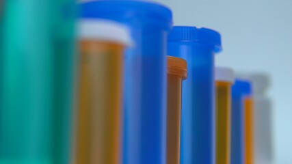 Different pills bottles macro close up shot. Pharmacy table. Modern drug and pharmacy industry concept. Research and development medicines to prevent or treat coronavirus COVID idea.