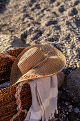 Summer concept. Woven basket with a straw hat and picnic blanket