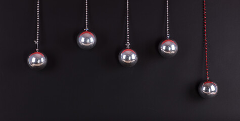 Fototapeta na wymiar hanging christmas silver balls isolated on black background