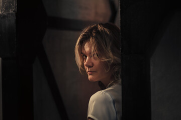 young woman looking at camera at night indoors