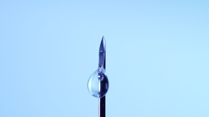 Vaccine dripping from sterile needle syringe. Concept of medical research development and production of vaccine against coronavirus, COVID 19. Drugs and medications for pharmaceutical industry.