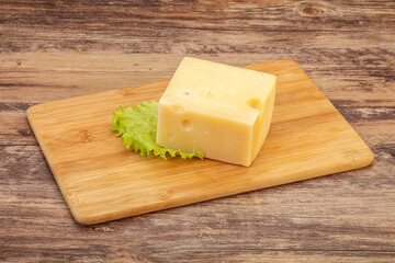 Emmental cheese over wooden board