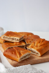 Homemade pie stuffed with beef and chicken on a white wooden table