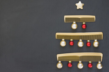 Christmas tree made of gold combs on a dark gray background. New year's template for a hair salon with space for text. Holiday banner with Barber accessories.