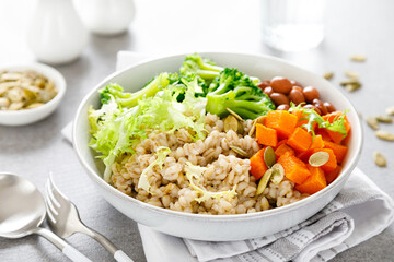 Vegetarian lunch bowl with pearl barley, red beans, broccoli and butternut squash