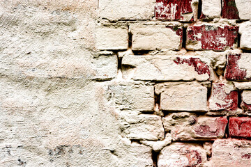Texture of a brick wall with cracks and scratches which can be used as a background