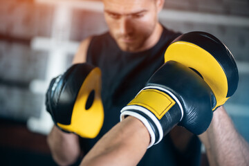 close up of man boxing sparring or fighting in boxing gloves at ring