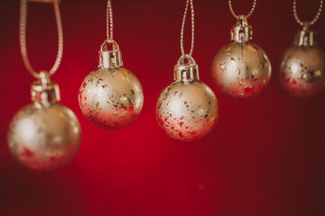 Golden christmas balls on red background. Christmas background.	