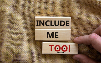 Wooden blocks with words 'include me too'. Beautiful canvas background, male hand. Copy space. Better inclusion concept.