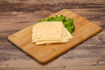 Sliced yellow cheese over board