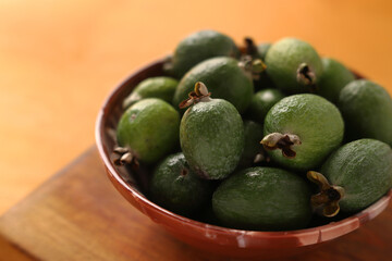 feijoa in a bowl on a wooden background. Close-up.