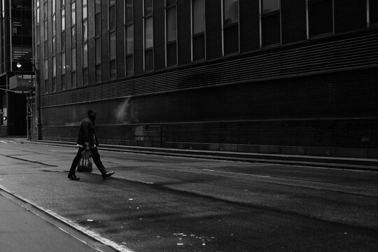 Side View Of Man Walking On Street In City