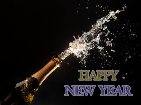 Happy new year theme with splashing champagne