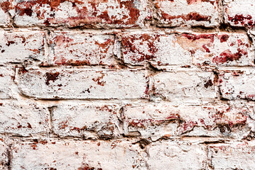 Texture of a brick wall with cracks and scratches which can be used as a background