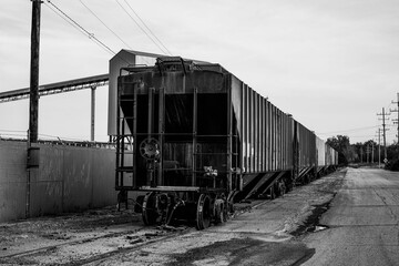 Fototapeta na wymiar A small train and train cars sitting outside of the salt mines on Lake Erie in Northeast Ohio.