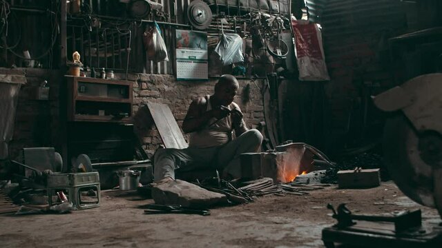 Rural blacksmith working in old traditional workshop
