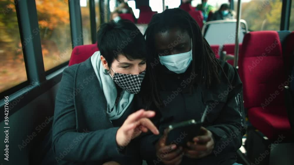Poster passengers in masks are actively talking on a commuter bus. viruses can be transmitted from person t