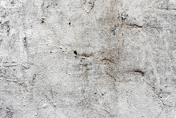Texture of a concrete wall with cracks and scratches which can be used as a background