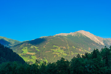 Fototapeta na wymiar Mountain valley village landscape in Venediger alps . Mountain green valley village view austria near matrei in osttirol