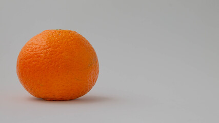 closeup shot of an orange on white gray surface