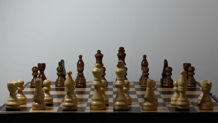 Chessboard with chess pieces on white background