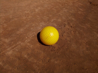 Yellow ball on the wet sand by the sea. Space for text