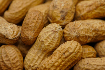 A lot of peanuts on dark table
