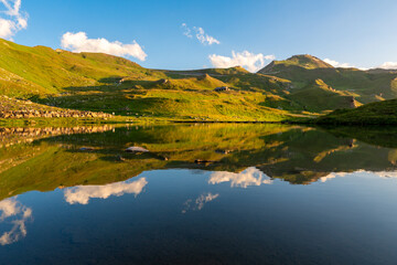 Fototapeta premium Sunrise view on lake on grossglockener with reflection. Location Grossglockner high alpine road, Austria, Europe. National park in Tyrol.