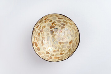 White coconut shell bowl with pearl seashell pieces. Culinary, dishes concept. Top view, flat lay, copy space